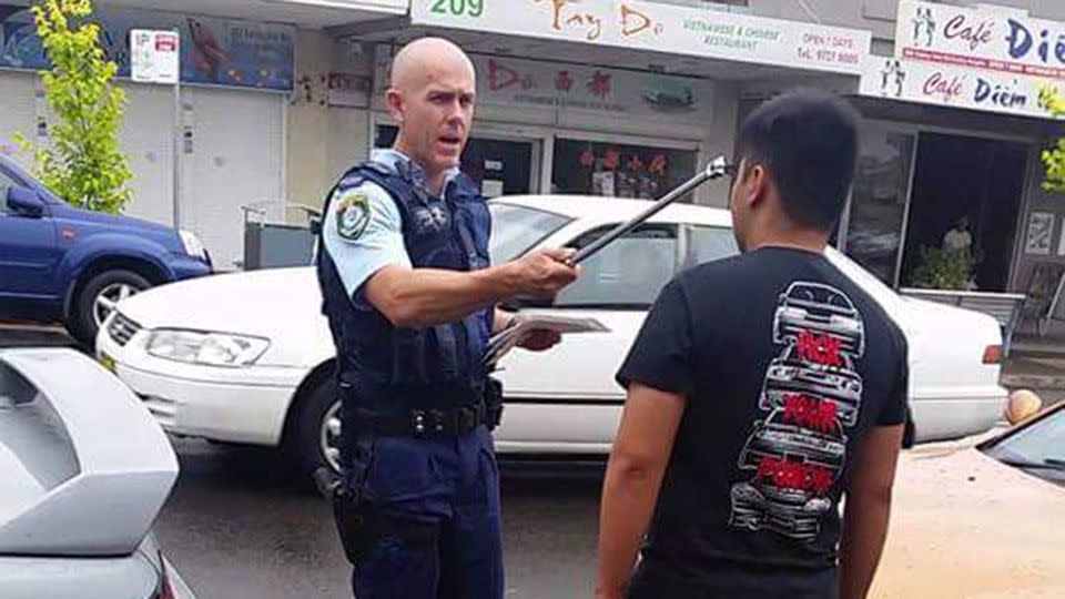 Images of Senior Constable Murphy holding a tyre iron to a young driver's head have surfaced just days after he was slammed for his treatement towards various Sydney motorists. Source: Facebook