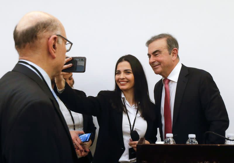 Former Nissan chairman Carlos Ghosn poses for a selfie picture during a news conference at the Lebanese Press Syndicate in Beirut