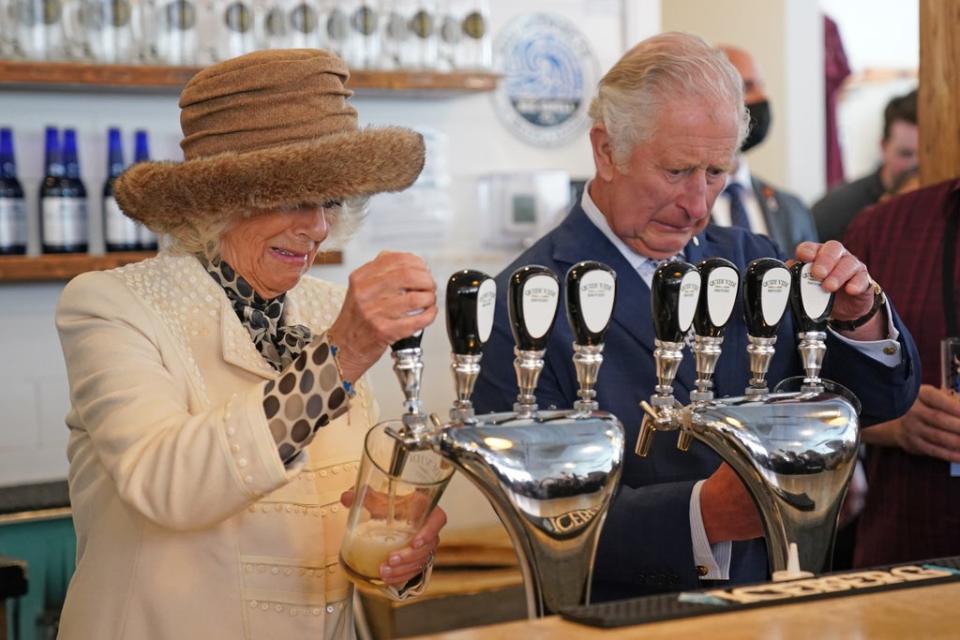 The Prince of Wales and Duchess of Cornwall pulled pints during their visit to the Quidi Vidi Brewer (Jacob King/PA) (PA Wire)