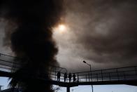 A smoke column rises from a fire in a factory in Santiago