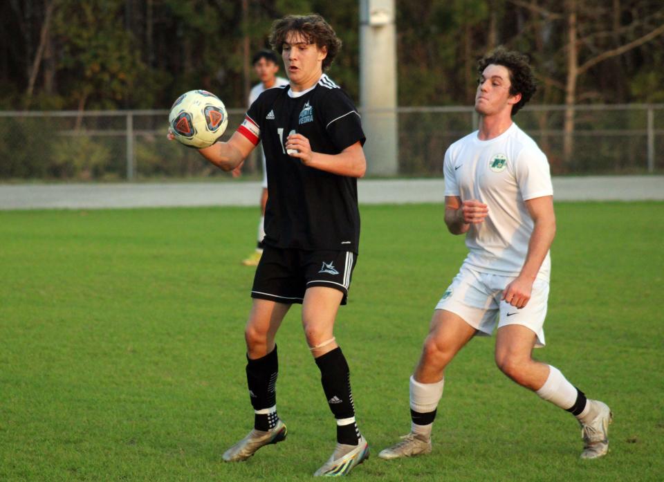 Ponte Vedra midfielder Mark Romano (10) controls the ball as Nease midfielder Jacob True (6) defends  during an FHSAA District 3-6A boys soccer semifinal on January 30, 2023. [Clayton Freeman/Florida Times-Union]