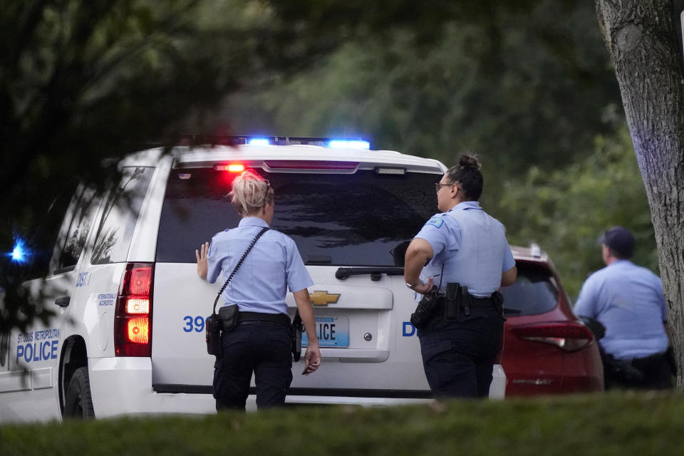 Police take up positions near the scene of a shooting Saturday, Aug. 29, 2020, in St. Louis. The St. Louis Police Department says two of their officers have been shot and a suspect is believed to be barricaded in a house nearby. (AP Photo/Jeff Roberson)