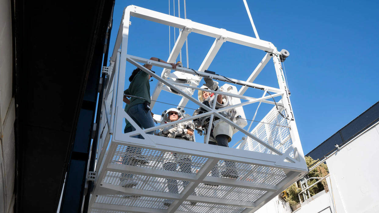  NASA astronauts Nicole Mann (center) and Douglas "Wheels" Wheelock test a SpaceX Starship elevator in support of future Artemis moon missions, in a picture published in December 2023. 