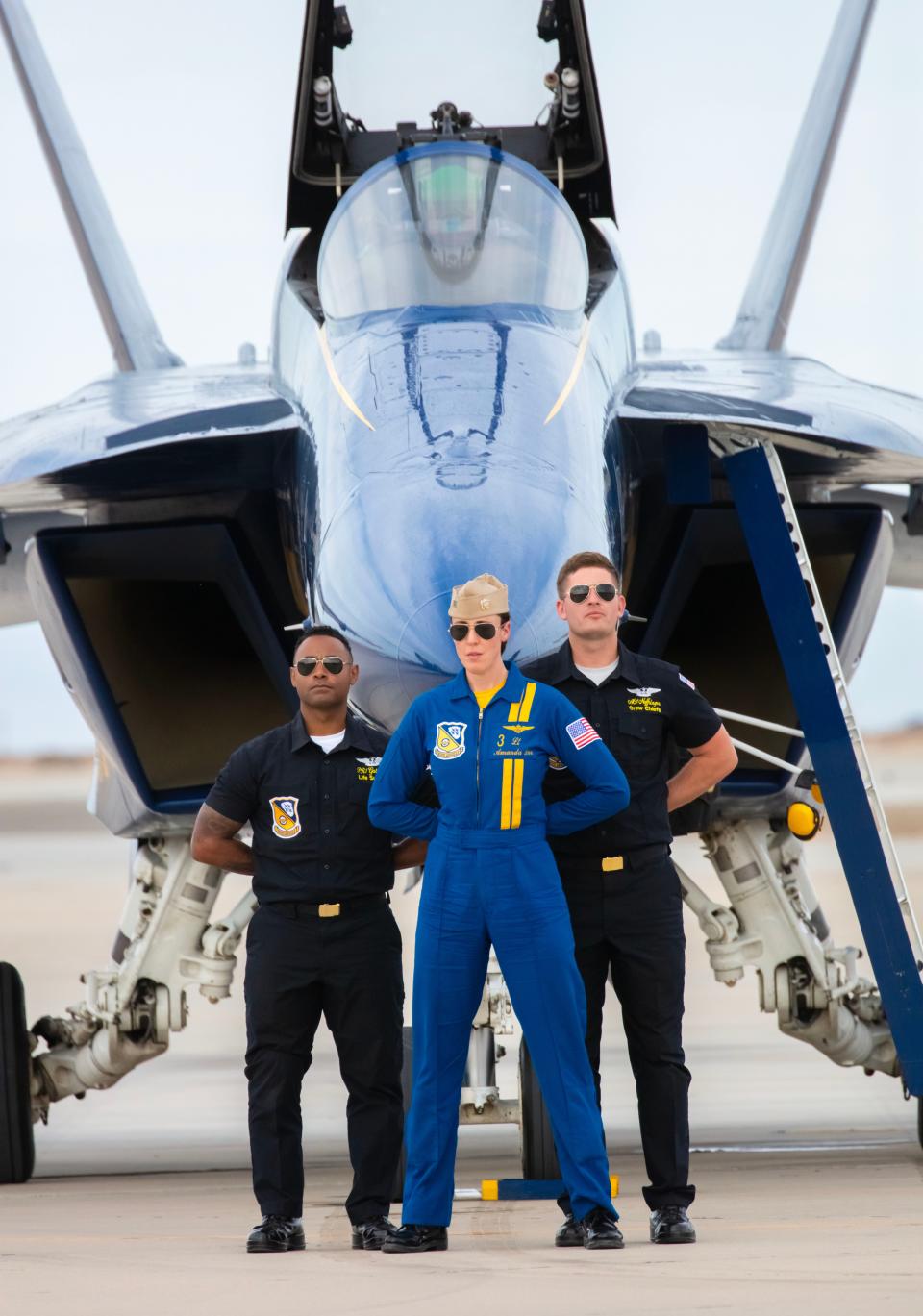 After completing her first public air show performance as a Blue Angel pilot, U.S. Navy Lt. Amanda Lee poses with her crew in front of her F/A-18E/F Super Hornet.