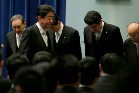 Japan's Prime Minister Shinzo Abe (2nd L) leaves a news conference after deciding on his cabinet following parliament reconvening after the general election, at his official residence in Tokyo, Japan November 1, 2017. REUTERS/Toru Hanai