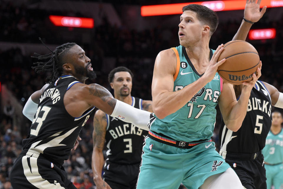 San Antonio Spurs' Doug McDermott (17) drives against Milwaukee Bucks' Wesley Matthews during the first half of an NBA basketball game, Friday, Nov. 11, 2022, in San Antonio. (AP Photo/Darren Abate)