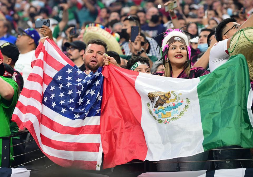 Fans hold USA and Mexico flags at the start of the Concacaf Gold Cup football match final between Mexico and USA at the Allegiant stadium in Las Vegas, Nevada on August 1, 2021. (Photo by Frederic J. Brown / AFP) (Photo by FREDERIC J. BROWN/AFP via Getty Images)