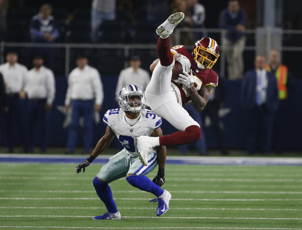 Washington Redskins wide receiver Robert Davis (19) makes a catch over Dallas Cowboys cornerback Byron Jones (31) during the second half of an NFL football game in Arlington, Texas, Thursday, Nov. 22, 2018. (AP Photo/Ron Jenkins)