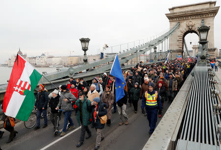 People take part in a protest against a proposed new labor law, billed as the "slave law", on the Chain Bridge in Budapest, Hungary, January 19, 2019. REUTERS/Bernadett Szabo