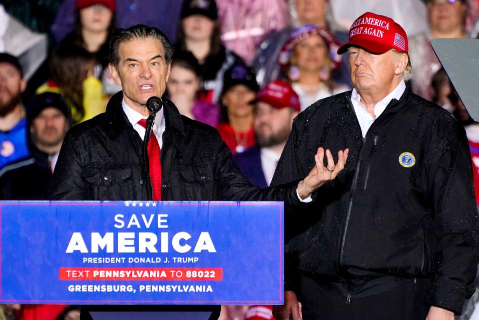 Pennsylvania Senate candidate Mehmet Oz is accompanied by former President Donald Trump at a campaign rally in Greensburg, Pa., on May 6.