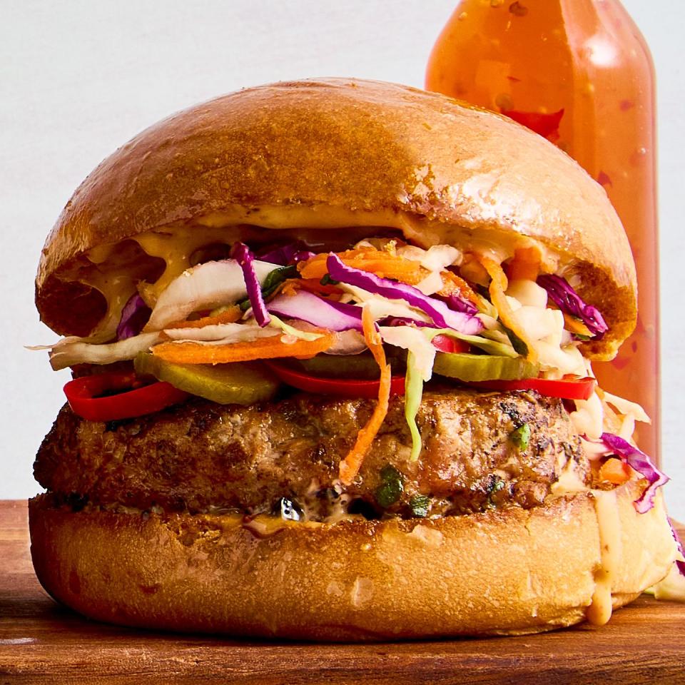 a ginger, garlic, and scallion studded turkey patty, pickled spicy peppers and cucumbers, a bright, crisp cabbage slaw, and plenty of sweet chili mayo all on a shiny, fluffy brioche bun