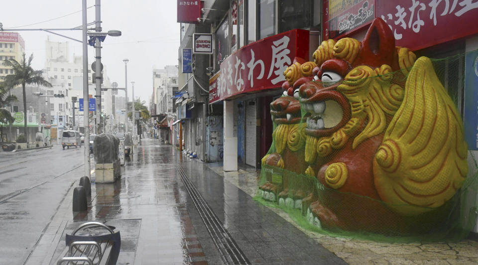 A main street is deserted as Typhoon Khanun approaches Naha city, Okinawa prefecture, southern Japan, Saturday, Aug. 5, 2023. Residents of Japan's southwestern islands were warned of high winds and rain Friday through the weekend as Typhoon Khanun made a U-turn and is now moving back east. (Kyodo News via AP)