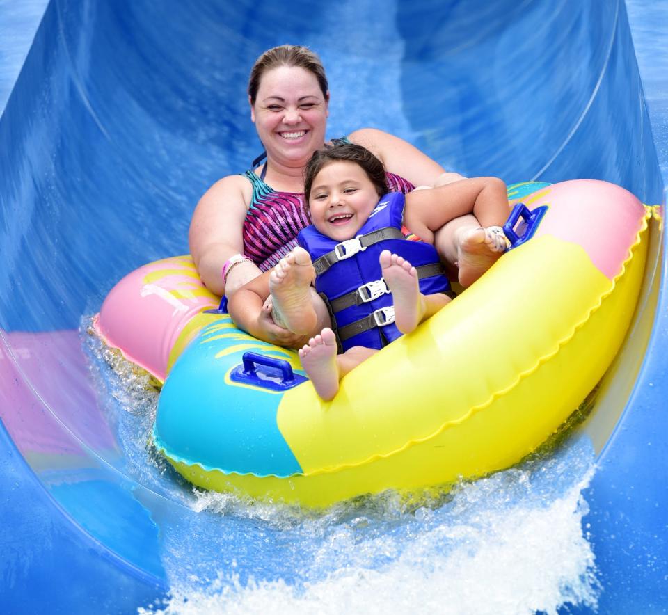 A mother and child tube down a slide at 7th Inning Splash in Piedmont.