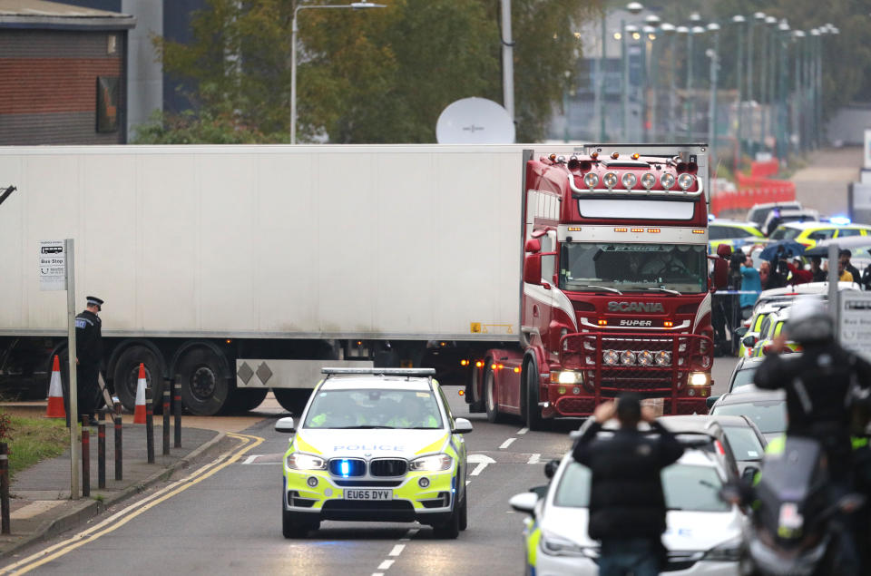 The container lorry where 39 people were found dead inside leaves Waterglade Industrial Park in Grays, Essex, heading towards Tilbury Docks under police escort.