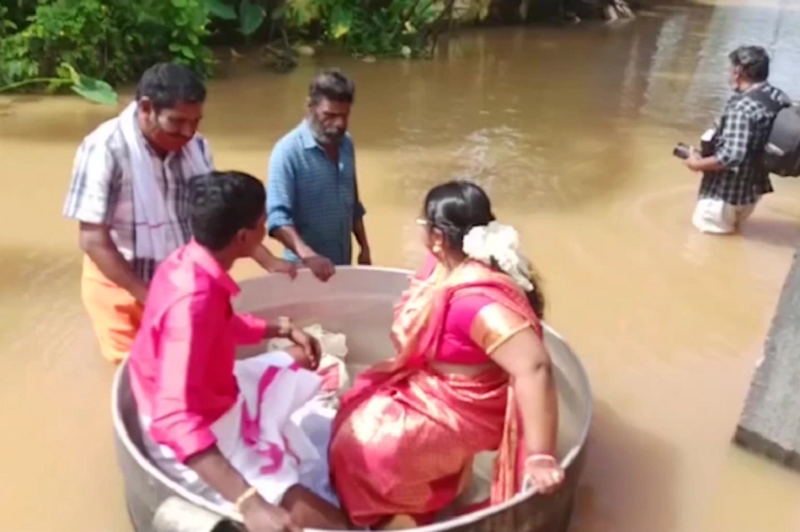 Due to flooding, a couple in Kerala, India had to travel to their wedding venue in a cooking pot. ― AFP pic