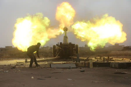 Popular Mobilization Forces (PMF) fire towards Islamic State militants during a battle on the outskirts of Al-Ba'aj, west of Mosul, Iraq May 26, 2017. REUTERS/Stringer