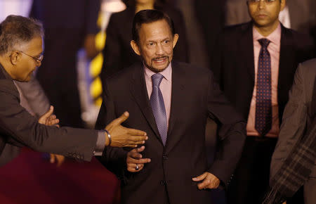 Brunei's Sultan Hassanal Bolkiah (C) walks towards his car after arriving at Air Force Station Palam in New Delhi, India, January 24, 2018. REUTERS/Adnan Abidi