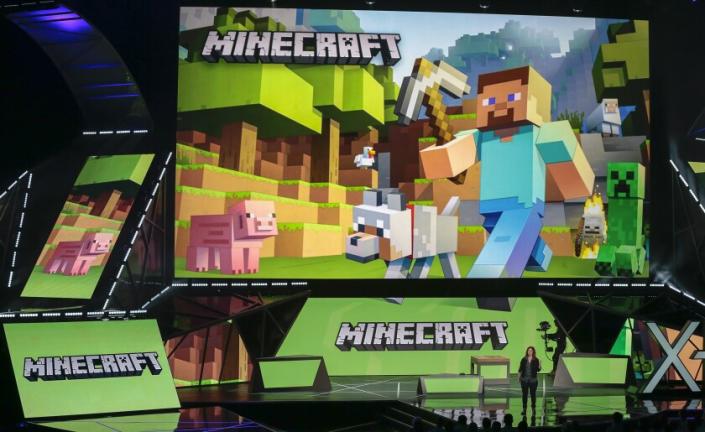 FILE - Lydia Winters shows off Microsoft's &quot;Minecraft&quot; built specifically for HoloLens at the Xbox E3 2015 briefing before Electronic Entertainment Expo, June 15, 2015, in Los Angeles. Security experts around the world raced Friday, Dec. 10, 2021, to patch one of the worst computer vulnerabilities discovered in years, a critical flaw in open-source code widely used across industry and government in cloud services and enterprise software. Cybersecurity experts say users of the online game Minecraft have already exploited it to breach other users by pasting a short message into in a chat box. (AP Photo/Damian Dovarganes, File)