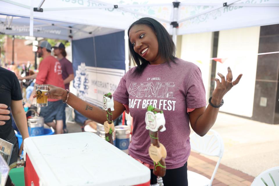 Kent State University alum and Kent Jaycee’s volunteer Jaliah Neely pours sample of beer from Hudson’s Hop Tree Brewery during the annual Kent Jaycees Craft Beer Fest.