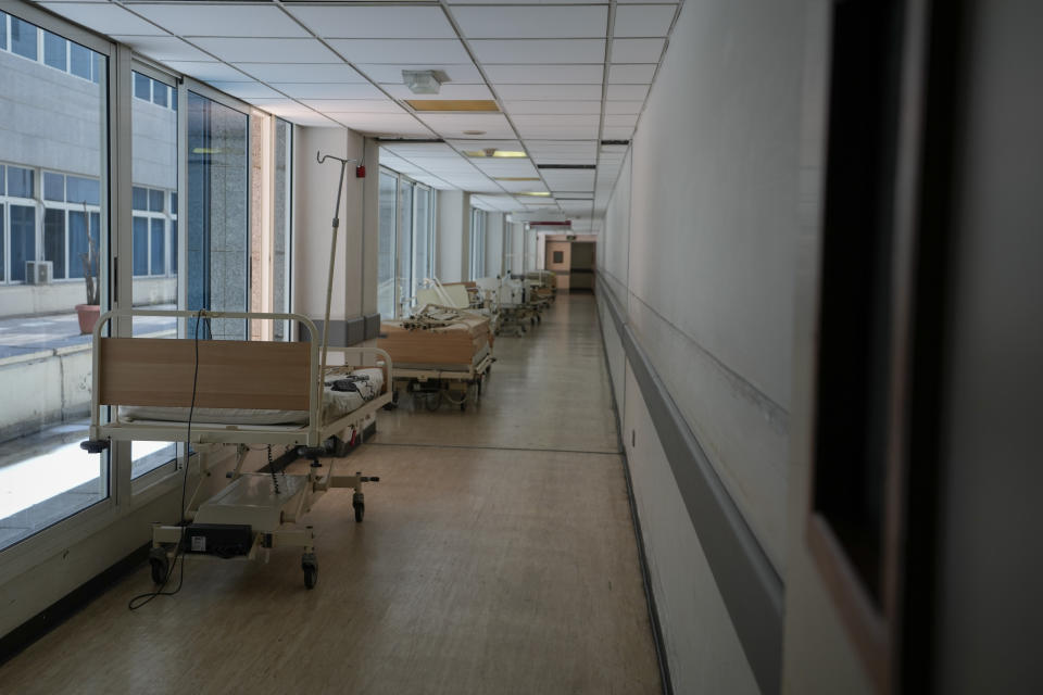 Unusable beds seen in a corridor of the government-run Rafik Hariri University Hospital in Beirut, Lebanon, Wednesday, Aug. 11, 2021. Many private hospitals, who offer 80% of Lebanon's medical services, are shutting down because of lack of resources or turning away patients who can't pay. (AP Photo/Hassan Ammar)