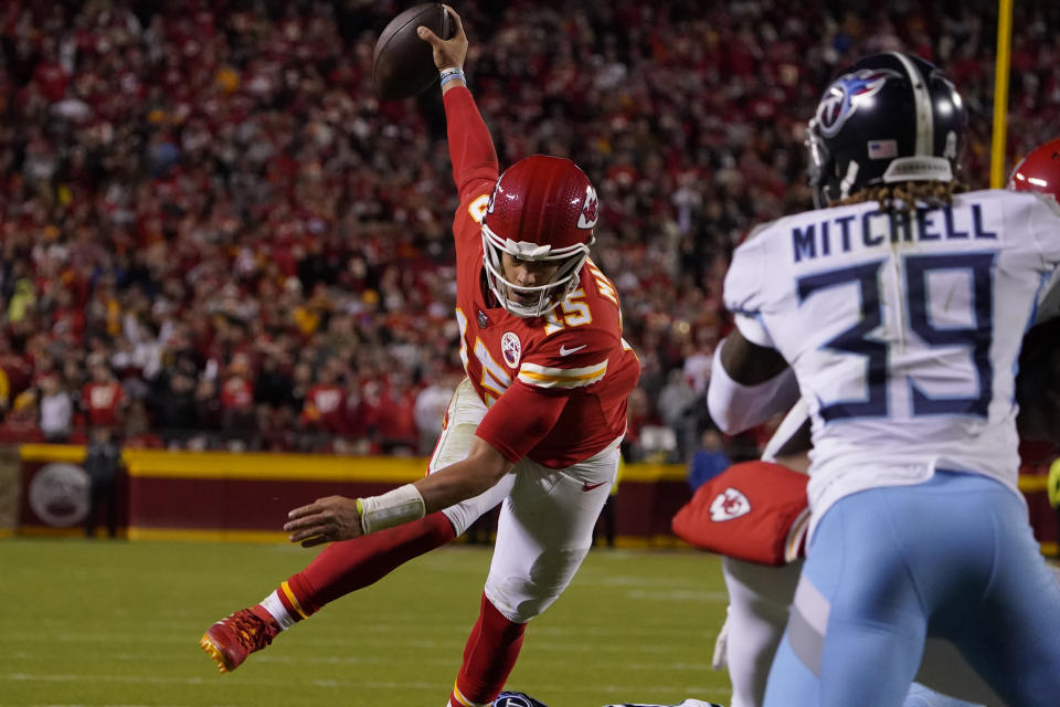 Kansas City Chiefs quarterback Patrick Mahomes (15) scores on a touchdown run as Tennessee Titans cornerback Terrance Mitchell (39) defends during the second half of an NFL football game Sunday, Nov. 6, 2022, in Kansas City, Mo. (AP Photo/Ed Zurga)