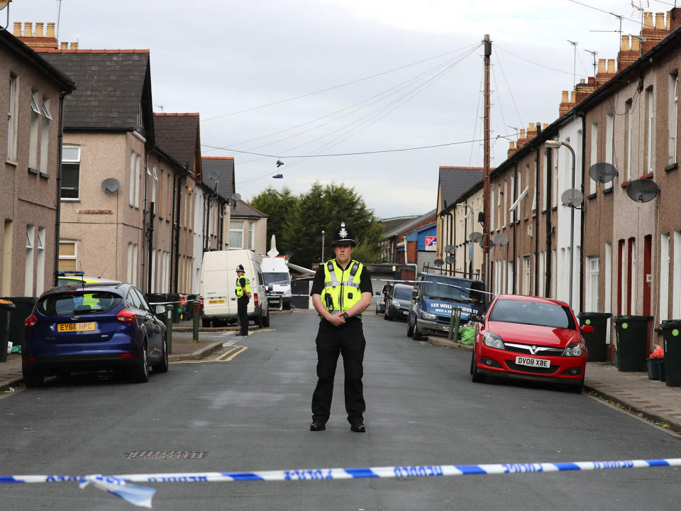 A police officer stands about a cordon near a home being searched in relation to the Parsons Green attack on 20 September in Newport, Wales: Getty