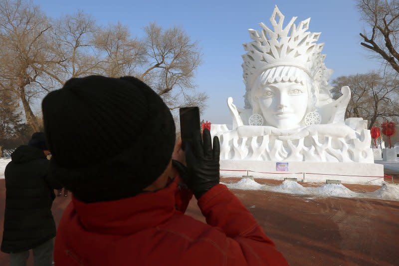 A tourist takes a picture of a snow sculpture during the 33rd Harbin International Ice and Snow Sculpture Festival in Harbin, the capital of China's Northeastern Heilongjiang rovince, on January 7. On November 22, 1972, the U.S. State Department ended a 22-year ban on U.S. travel to China. File Photo by Stephen Shaver/UPI