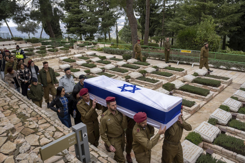 Israeli soldiers carry the flag-draped casket of reservist Gavriel Shani during his funeral at Mt. Herzl military cemetery in Jerusalem, Wednesday, Jan. 31, 2024. Shani, 28, was killed during Israel's ground operation in the Gaza Strip, where the Israeli army has been battling Palestinian militants in the war ignited by Hamas' Oct. 7 attack into Israel. (AP Photo/Ohad Zwigenberg)