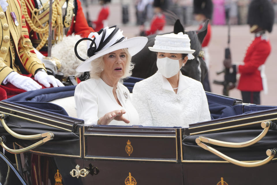 Britain's Queen Camilla, left,and Japan's Empress Masako, ride in an open carriage during the ceremonial welcome for the State Visit to Britain of the Japanese Emperor and Empress, in London, Tuesday, June 25, 2024. (Jonathan Brady, Pool Photo via AP)