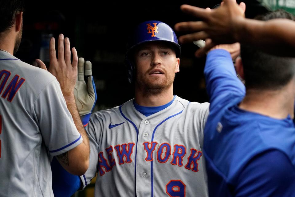 New York Mets' Brandon Nimmo celebrates with teammates after scoring on a single by Pete Alonso during the fifth inning of a baseball game against the Chicago Cubs in Chicago, Sunday, July 17, 2022.