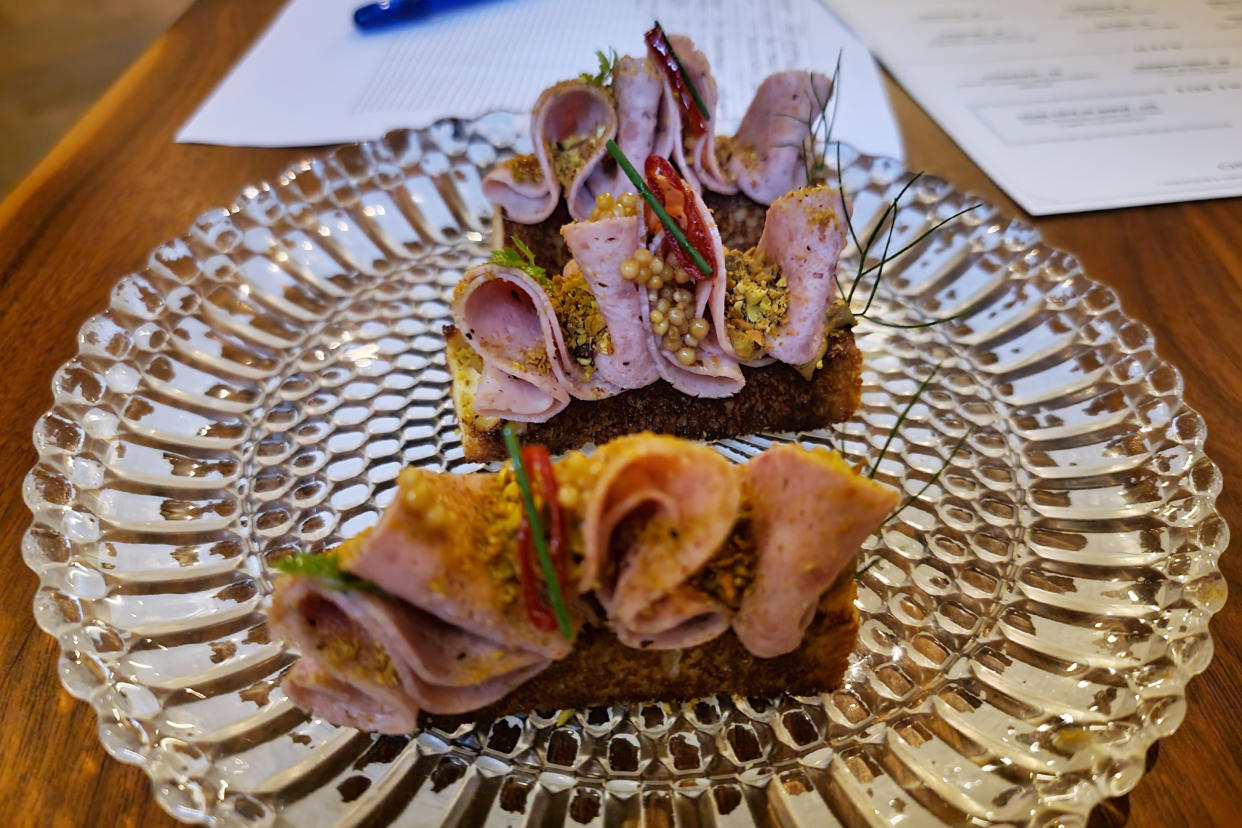 The duck mortadella atop brioche with pistachio mustard at Francie. (Courtesy Eric Finkelstein)