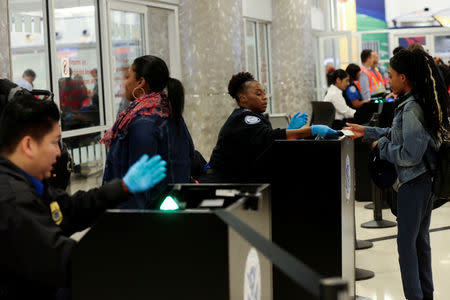 Transportation Security Administration (TSA) agents screen passengers at a security checkpoint at Hartsfield-Jackson Atlanta International Airport amid the partial federal government shutdown, in Atlanta, Georgia, U.S., January 18, 2019. REUTERS/Elijah Nouvelage