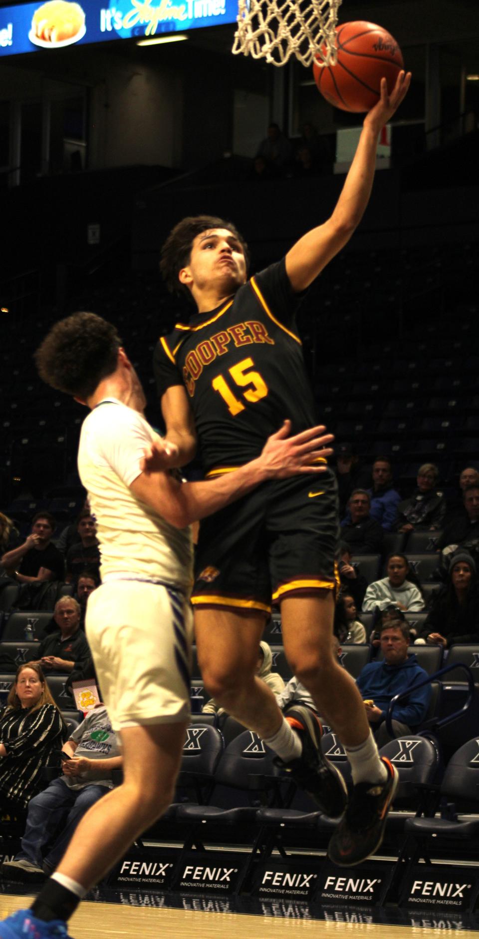 Cooper junior Yamil Rondon glides in for a layup as Cooper boys basketball defeated Cincinnati Hills Christian Academy 79-63 in the Hardwood Holiday Classic Jan. 14, 2024 at Xavier University's Cintas Center. Rondon finished with 15 points.