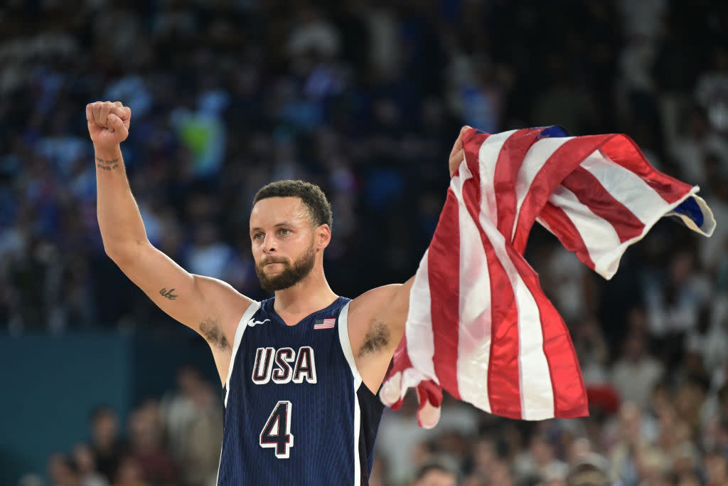 USA's #04 Stephen Curry celebrates after the USA won the men's Gold Medal basketball match between France and USA during the Paris 2024 Olympic Games at the Bercy Arena in Paris on August 10, 2024. <span class="copyright">DAMIEN MEYER—AFP/Getty Images</span>