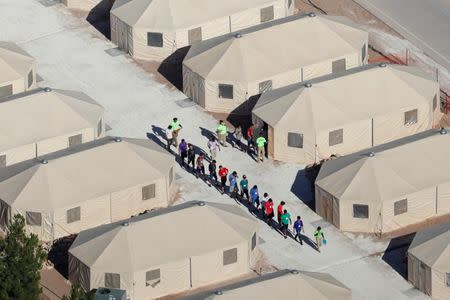 FILE PHOTO: Immigrant children, many of whom have been separated from their parents under a new "zero tolerance" policy by the Trump administration, are being housed in tents next to the Mexican border in Tornillo, Texas, U.S., June 18, 2018. REUTERS/Mike Blake/File Photo