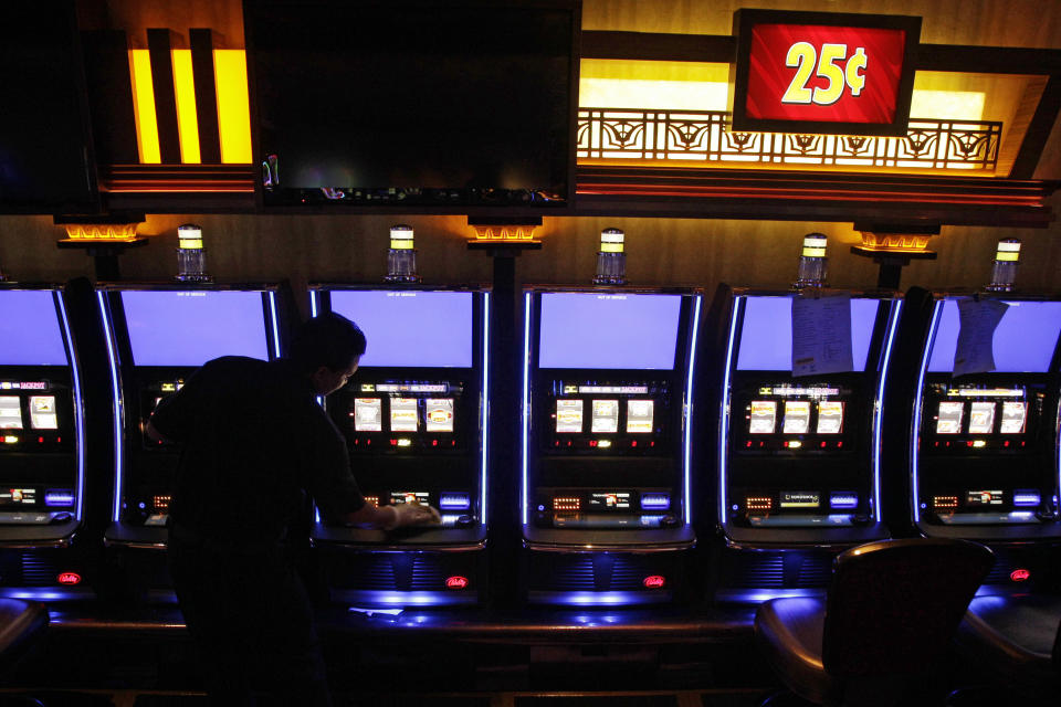 In this May 9, 2012 photo, Rudra Khadka cleans slot machines inside the new Horseshoe Cleveland Casino. Ohio's first casino is scheduled to open to the public on Monday, May 14, 2012. (AP Photo/Amy Sancetta)