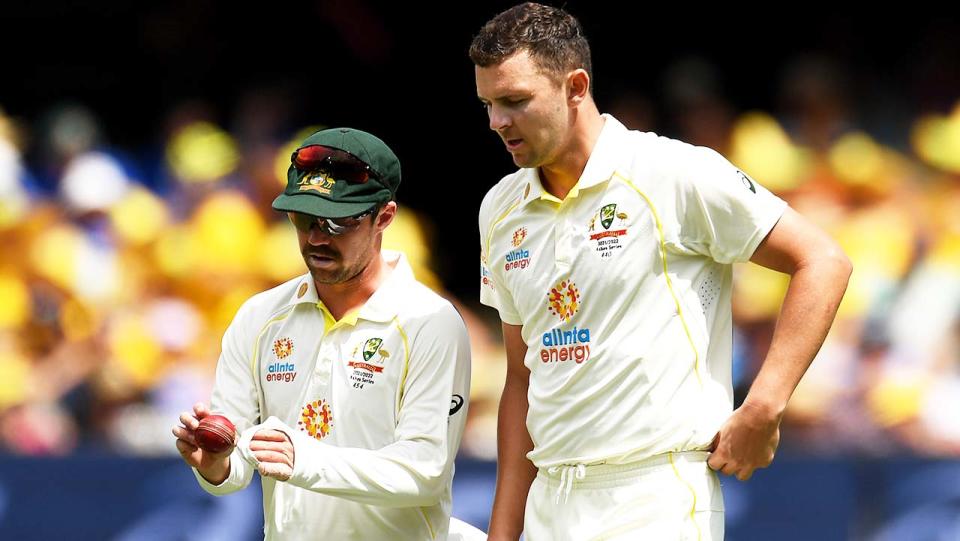 Josh Hazlewood (pictured right) talking to teammate Travis Head.