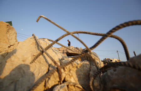 A man inspects the rubble of a Palestinian house which was destroyed by Israeli troops during an Israeli raid in the West Bank city of Jenin September 1, 2015. REUTERS/Mohamad Torokman