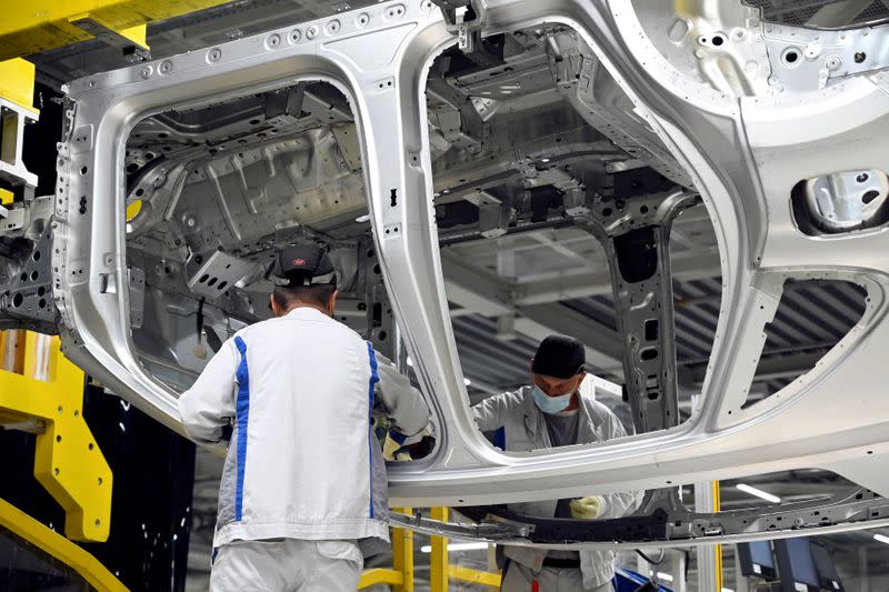 FILE PHOTO: Employees work on an assembly line as the Volkswagen construction plant reopens after closing down due to the coronavirus disease (COVID-19) outbreak in Bratislava