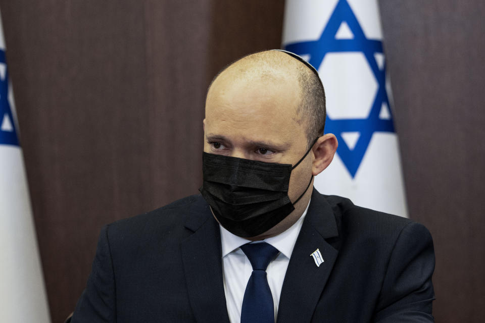 Israeli Prime Minister Naftali Bennett chairs the weekly cabinet meeting in Jerusalem, Sunday, Dec. 12, 2021. Bennett announced that he would make the first official visit by a sitting premier to the United Arab Emirates on Sunday as part of a blitz of regional diplomacy amid the backdrop of struggling nuclear talks with Iran. (AP Photo/Tsafrir Abayov, Pool)