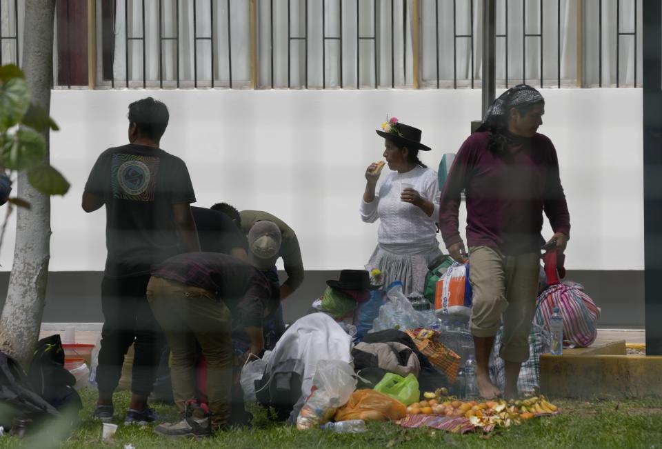 Photographed through a fence, people who traveled to the capital from across the country camp out at San Marcos University during an ongoing protest against Peruvian President Dina Boluarte's government and Congress in Lima, Peru, Friday, Jan. 20, 2023. Protesters are seeking immediate elections, Boluarte's resignation, the release of ousted President Pedro Castillo and justice for up to protesters killed in clashes with police. (AP Photo/Martin Mejia)