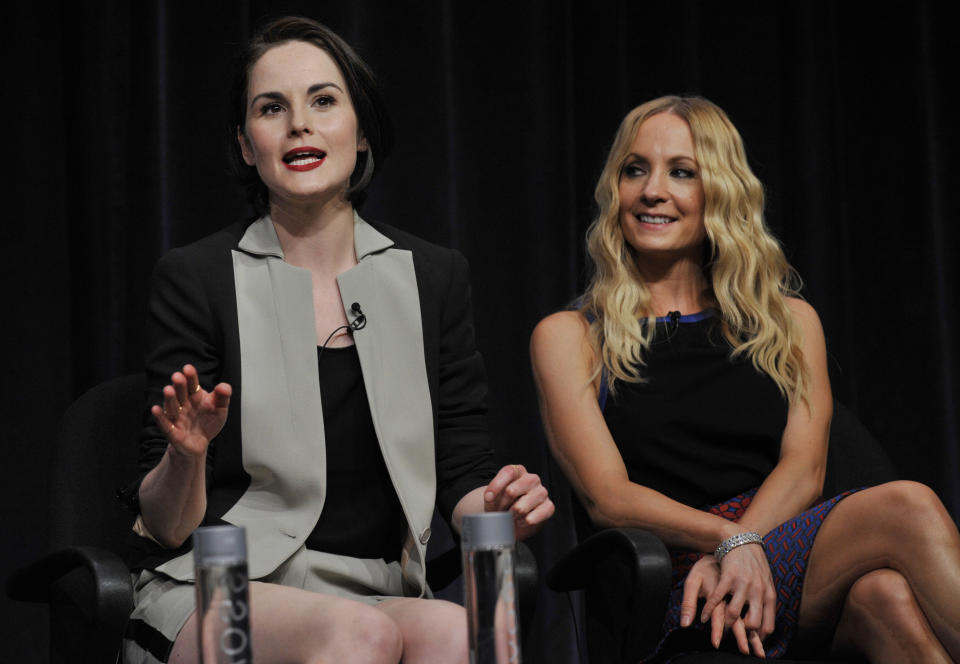 Michelle Dockery, left, a cast member in the Masterpiece series "Downton Abbey," addresses a reporter as fellow cast member Joanne Froggatt looks on at the PBS Summer 2013 TCA press tour at the Beverly Hilton Hotel on Tuesday, Aug. 6, 2013 in Beverly Hills, Calif. (Photo by Chris Pizzello/Invision/AP)