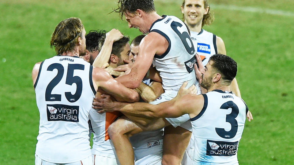 Callan Ward, pictured here celebrating with GWS teammates after kicking the match-sealing goal against Essendon.