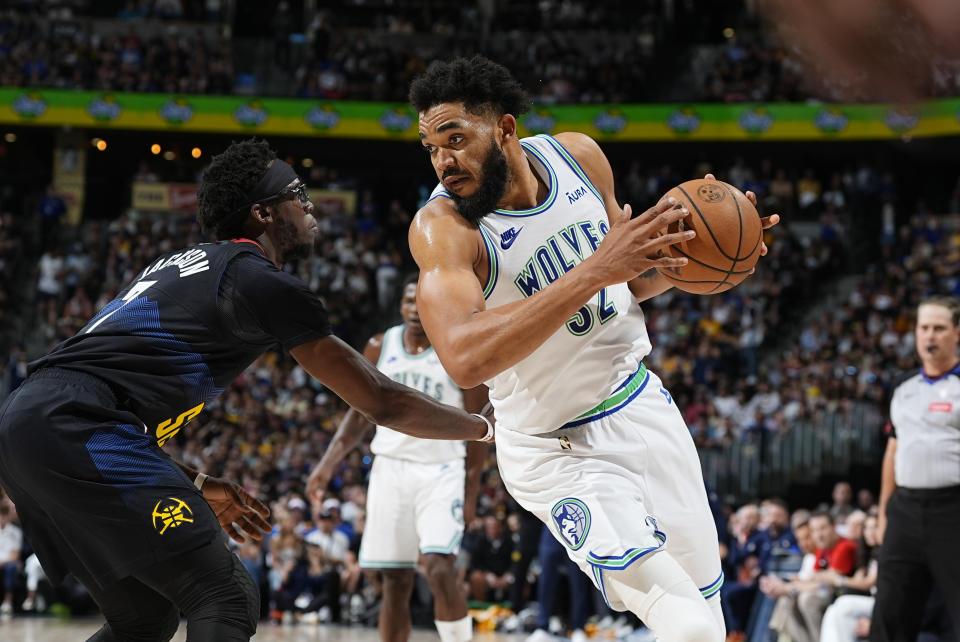 Minnesota Timberwolves center Karl-Anthony Towns, right, drives to the basket as Denver Nuggets guard Reggie Jackson defends in the second half of Game 7 of an NBA second-round playoff series, Sunday, May 19, 2024, in Denver. (AP Photo/David Zalubowski)