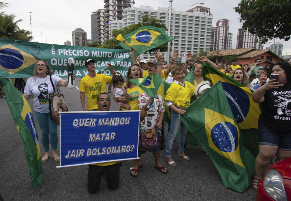 Supporters of Jair Bolsonaro, presidential candidate with the Social Liberal Party, gather in front of his house after general elections in Rio de Janeiro, Brazil, Sunday, Oct. 7, 2018. (AP Photo/Ricardo Borges)