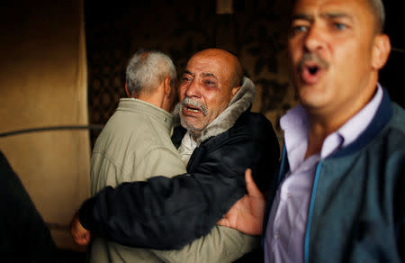 Palestinian relatives of Hamas gunman Mohammed Hejelah, who was killed in an Israeli air strike, mourn during his funeral in Gaza city April 12, 2018. REUTERS/Mohammed Salem