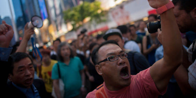 HONG KONG - OCTOBER 03:  Anti-Occupy supporters chant at the Occupy camp in Causeway Bay on October 3, 2014 in Hong Kong. Thousands of pro democracy supporters continue to occupy the streets surrounding Hong Kong's Financial district. The protesters are calling for open elections and the resignation of Hong Kong's Chief Executive Leung Chun-ying, who last night agreed to hold talks with the protest leaders in a bid to diffuse the growing unrest.  (Photo by Anthony Kwan/Getty Images) (Photo: )