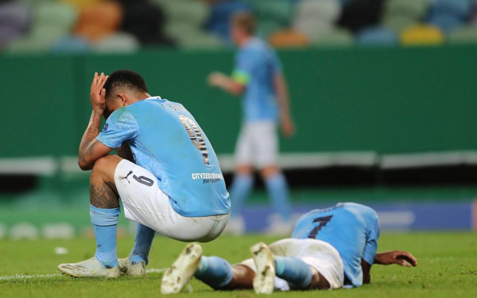 Manchester City's Gabriel Jesus, left, and Manchester City's Raheem Sterling react at the end of the Champions League quarterfinal soccer match between Lyon and Manchester City at the Jose Alvalade stadium in Lisbon - AP