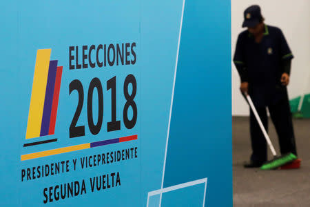 A worker cleans at polling station before the tomorrow's second round of the Colombian presidential election in Bogota, Colombia, June 16, 2018. REUTERS/Nacho Doce