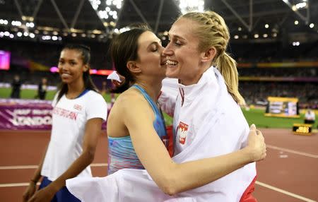 Athletics - World Athletics Championships – women's high jump final – London Stadium, London, Britain – August 12, 2017 – Neutral athlete Maria Lasitskene (gold) and Kamila Licwinko of Poland (bronze) after the competition. REUTERS/Dylan Martinez